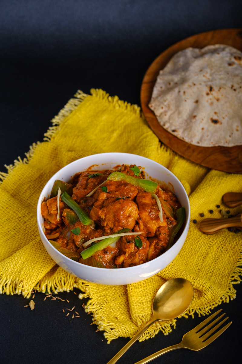 Murgh Jalfrazi in a white bowl on a yellow cloth at Queen’s of India Ubud Bali